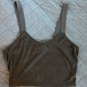 Gray crop top, with thick elastic straps.